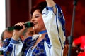 Elisabeta Turcu singing on a stage in Italy.