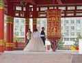 ELISTA, RUSSIA. The groom and the bride spin a prayer wheel with a mantra of Ohms of Manya Padme Hum. Pagoda of Seven Days