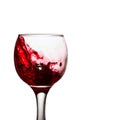 Elite alcoholic drink red wine splashing in a glass with grapes Royalty Free Stock Photo