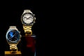 Elite men`s wristwatches on a metal bracelet on a black background. Copy space