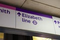 Elizabeth Line text with arrow symbol on board at underground subway station