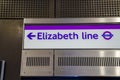 Elizabeth Line text with arrow symbol on metallic board at underground station