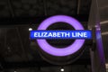 Elizabeth Line text on purple circle at underground subway station in London