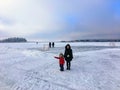 A mother and daughter enjoying winter by walking on the frozen lake of Astotin Lake