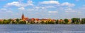 Panorama of Elk historic city center with neo-gothic church tower on shore of Jezioro Elckie lake in Masuria region of Poland