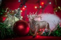 Elk toy Christmas ball garland tinsel blur on a red background Royalty Free Stock Photo