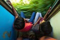 Ella, Sri Lanka 17 April 2018: Two teens riding on 2 class train and looking outside Royalty Free Stock Photo