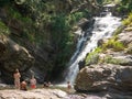 Ella, Sri Lanka - March 9, 2022: Beautiful view of the Ravana Ella waterfall, 25 meters high. People relax and bathe in cool water