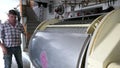 farmer works on a wine press machine to pressing out white wine gapes.