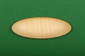 Ellipse shaped wooden sign on green background