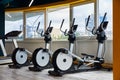 Moscow, Russia, 10.10.2019, Elliptical trainers standing in a row, gym with windows, view of the whole city Royalty Free Stock Photo