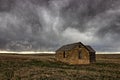 Ellis County, KS USA - Abandoned Limestone Farmhouse in the Midwest Prairie under Tempestuous Skies Royalty Free Stock Photo