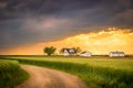 Ellis County, KS USA - Country Road with the Idyllic Midwestern Farmhouse Background