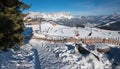 ELLMAU, TIROL/AUSTRIA, December 30th 2019 - mountain panorama Skiwelt Hartkaiser slope with chairlift and skiers, austrian alps