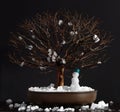 Elm bonsai tree with snowman