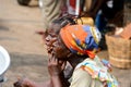 Unidentified Ghanaian women sit in Elmina market and look ahead