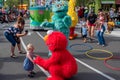 Elmo takes the hand of little girl in Sesame Street Party Parade at Seaworld. Royalty Free Stock Photo