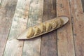 Elongated porcelain tray with serving of Japanese dumplings stuffed with meat, gyozas, cooked on the grill on wooden table