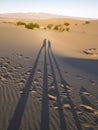 Elongated Shadow of Two People On Sand Royalty Free Stock Photo