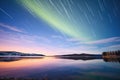 elongated streaks of aurora over a placid lake