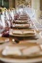 Elongated table with all the cutlery elegantly arranged and beautiful centerpieces ideal for decorating a wedding