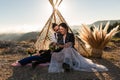 Elopement wedding in the mountains, rock and roll style. couple, teepee, sunset