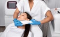 Elos epilation hair removal procedure on the face of a woman. Beautician doing laser rejuvenation on the chin in a beauty salon.