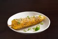 Elote in a white plate