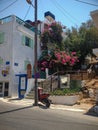 Elounda, Crete, Greece - September 2: Street of a Greek city, a motorcycle is parked. Hotel building. Booth with an ATM. Beautiful