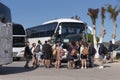 Group of travellers waiting to board their tour bus in Elounda, Crete.