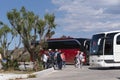 Tour buses and tourists departing their visit to Elounda, Crete.