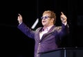 Elton John arms up in stage Royalty Free Stock Photo
