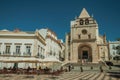 Square with tables and chairs of restaurant in front of Church