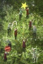 Elves decorating Christmas tree in snow