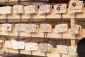 Ema tablets, Japanese wooden wishing board, hang on racks at temple in Tokyo, Japan on June 14, 2015