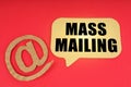 On a red surface, a symbol and a sign with the inscription - Mass Mailing