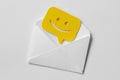 Email envelope with smiling message bubble on white background