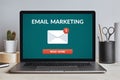 Email marketing concept on laptop screen on modern desk Royalty Free Stock Photo