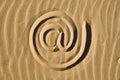 Email sign drawn in the sand