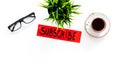 Email subscribe concept. Hand lettering subcribe on work desk with plant, glasses, cup of coffee on white background top