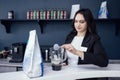 emale barista pours milkshake into glass with straw Royalty Free Stock Photo