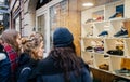 Emale women admiring the showcase window of a shoe store