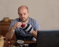 Emancipated man darning his socks