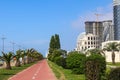 Embankment of Batumi with alley of palm trees, bicycle path and modern architecture Royalty Free Stock Photo