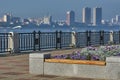 Embankment of the city of Blagoveshchensk, Russia. A flower bed with a wooden bench and purple flowers. Across the Amur Royalty Free Stock Photo