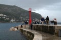 Embankment at the entrance to the old port of Dubrovnik with tourists Royalty Free Stock Photo