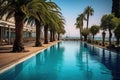 Embankment with palm trees with swimming pools in a park on the seashore