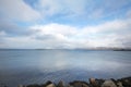 Embankment in Reykjavik over mountains and ocean, dramatic sky. Royalty Free Stock Photo