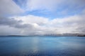 Embankment in Reykjavik over mountains and ocean, dramatic sky. Royalty Free Stock Photo