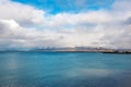 Embankment in Reykjavik over mountains and ocean, dramatic sky. Royalty Free Stock Photo